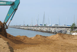CEA Project Logistics - Heliotrope 65 Catamaran Transport and Launch - digging out the beach