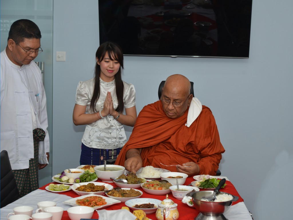 Monks eating meal in office