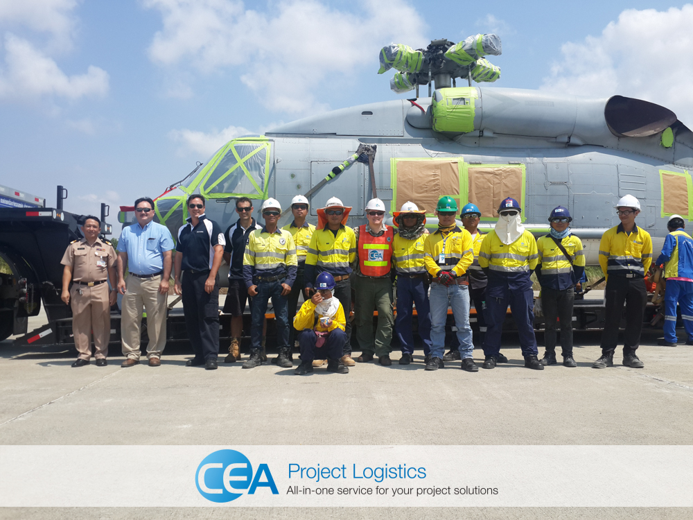 CEA Team pose for photo in front of seahawk helicopter